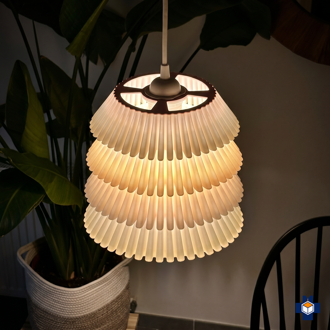 FALDA tiered-ruffle pendant glowing softly at night
